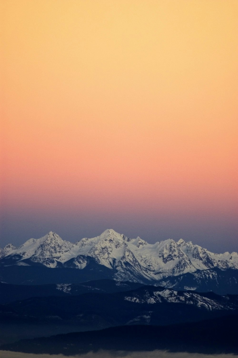 white mountains under orange sky