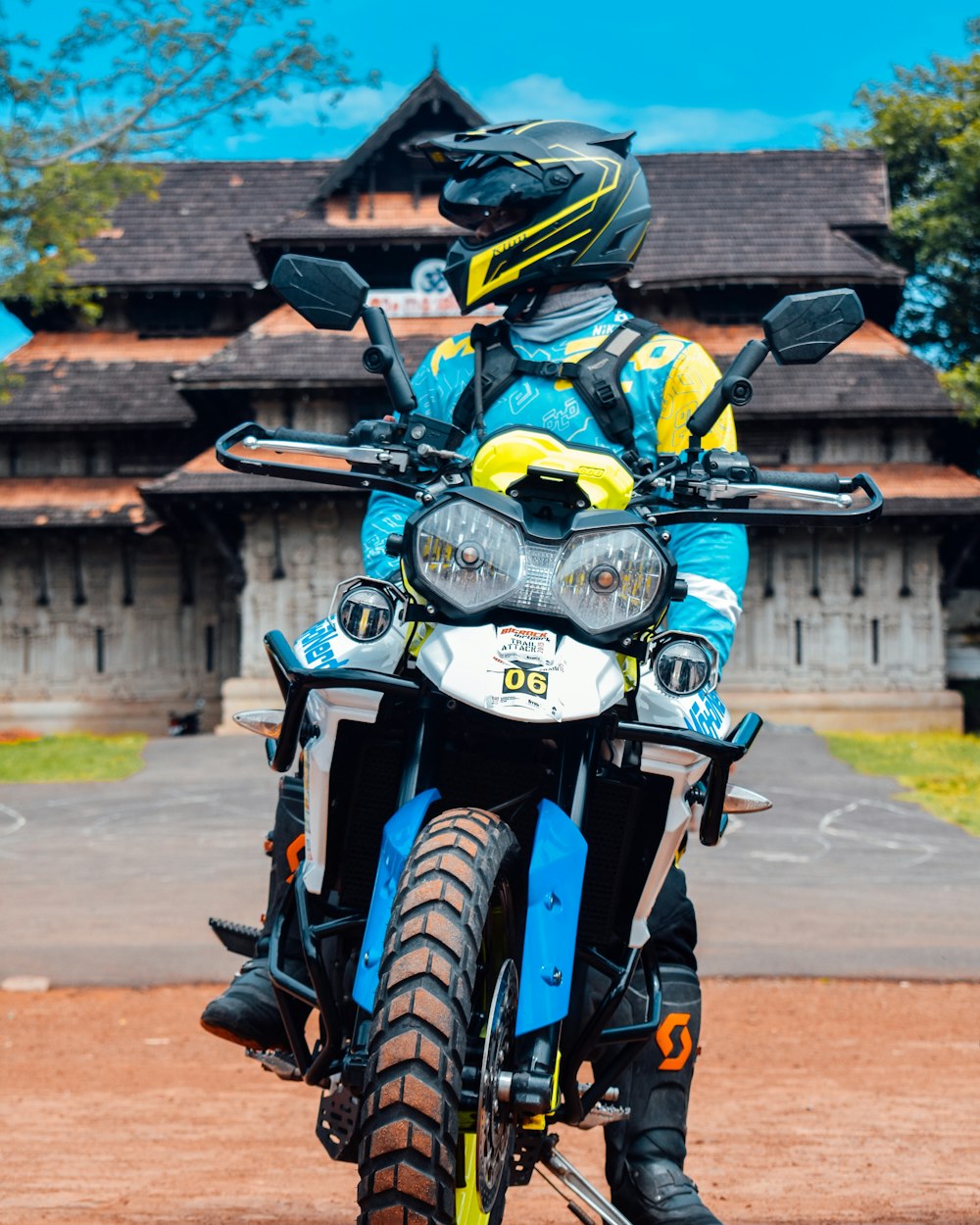 a person riding a motorcycle on a dirt road