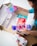 A person happily unboxing a package filled with trendy products at home.