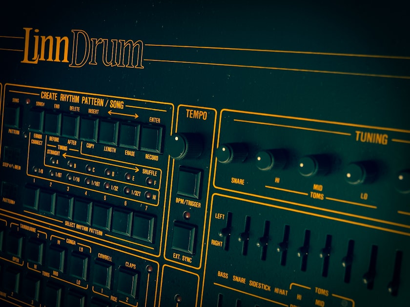 Close-up view of a vintage Linn Drum machine's face, showing the drum pad buttons and retro interface of this pioneering electronic percussion device