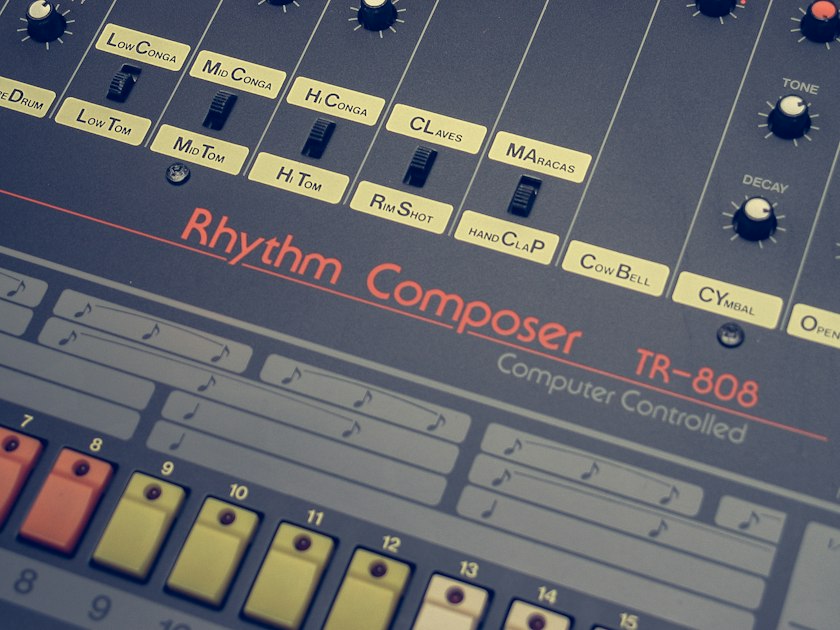A close-up of a classic Roland TR-808 Rhythm Composer, the hardware drum machine whose sound still shapes modern drum plugins