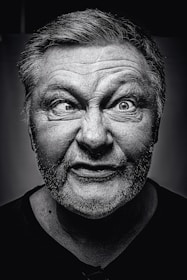 grayscale photography of man making silly face