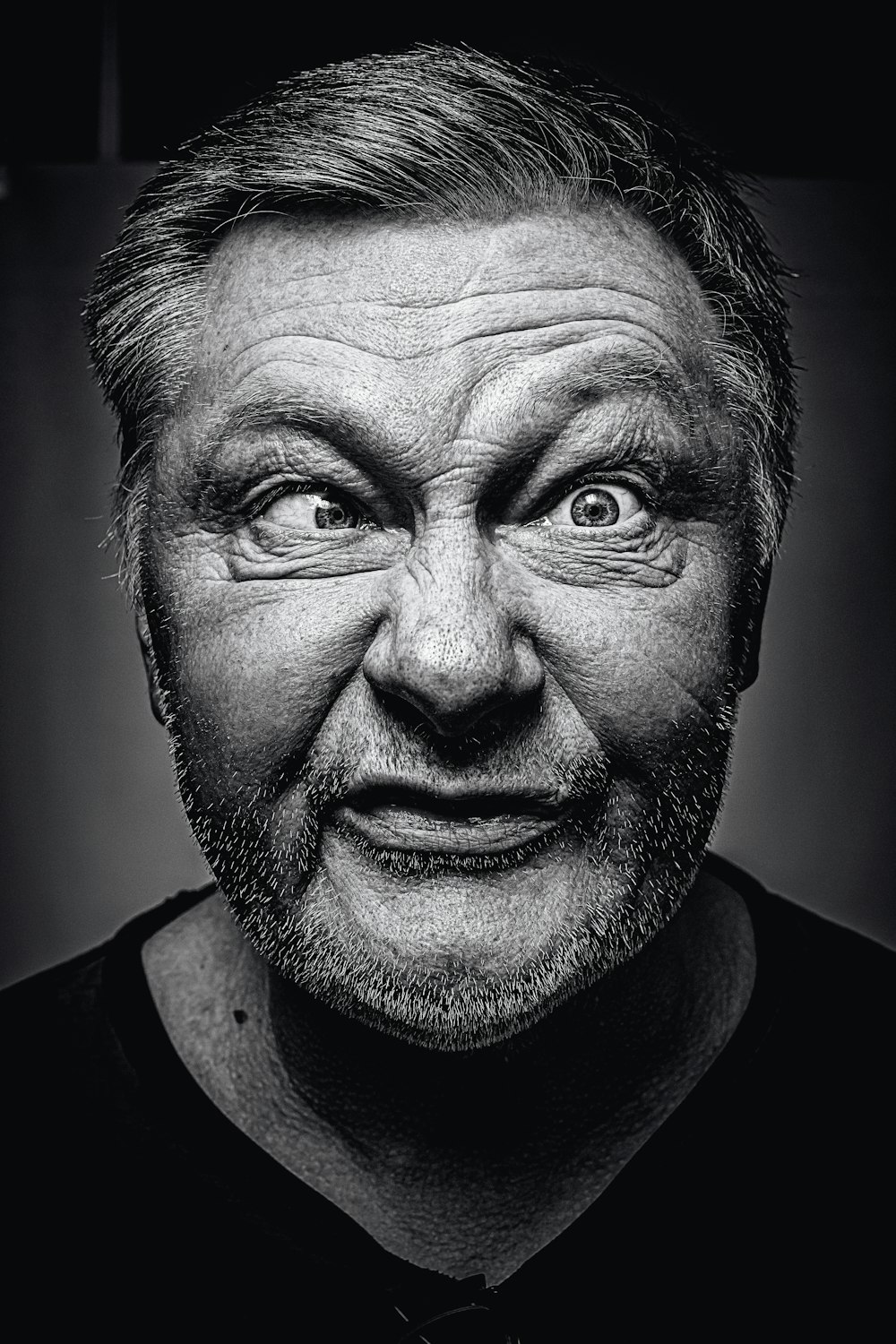 grayscale photography of man making silly face