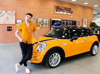 A friendly carsu team member assisting a happy customer beside a shiny pre-owned car.