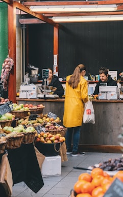 woman at the cashier inside fruits and vegetables store