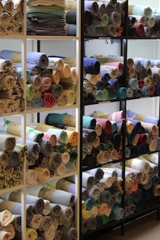 Shelves displaying natural linen fabrics with wooden accents in the store