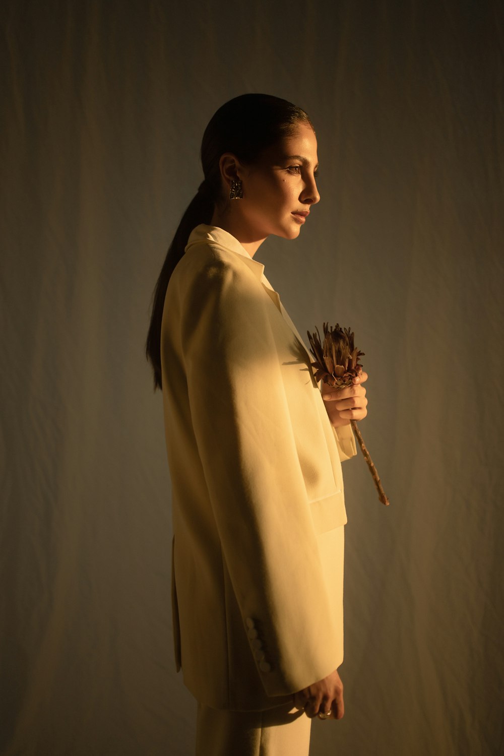 woman holding dried flower