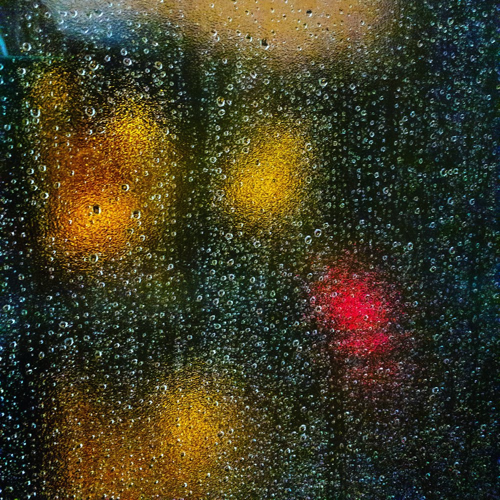 a close up of a traffic light on a rainy day