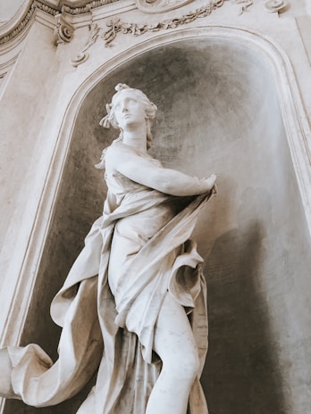 An elegant marble sculpture displayed in a gallery.