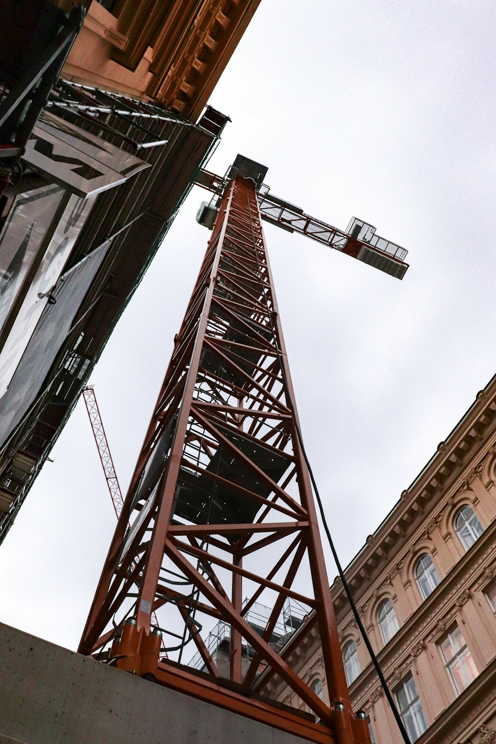 low-angle photography of tower crane during daytime