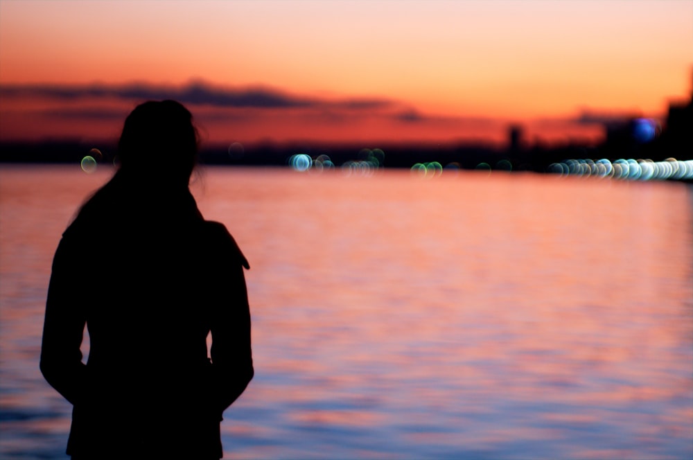 silhouette of woman near the ocean