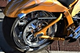 A custom paint job in Harley Davidson orange and black being carefully applied by hand.