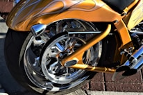 Close-up of a black and orange custom Harley Davidson motorcycle with detailed paintwork.