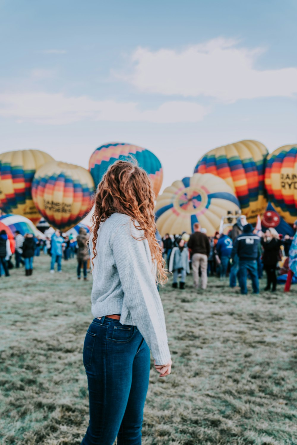 woman standing near hot air balloons