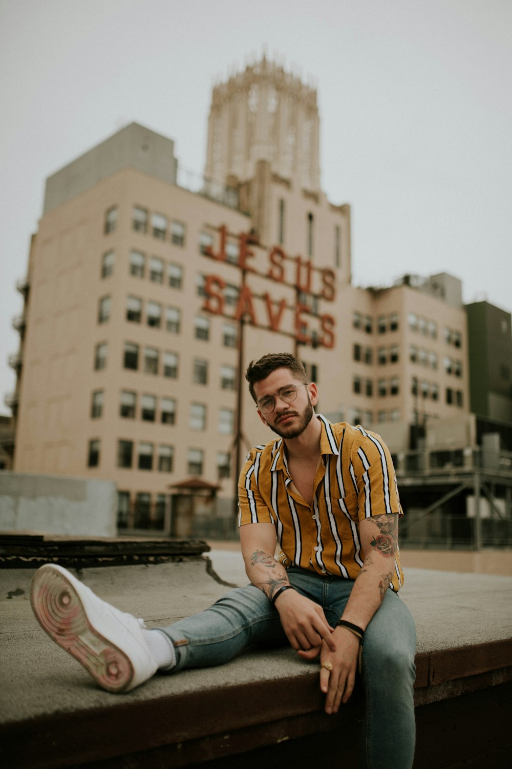 man wearing yellow and white striped shirt and grey denim jeans