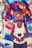 A vibrant street art mural featuring a cartoon-style character with large, colorful hair in shades of blue, purple, yellow, and pink. The character is depicted with closed eyes, expressing serenity, and holding a heart symbol. The background includes swirling, colorful patterns.