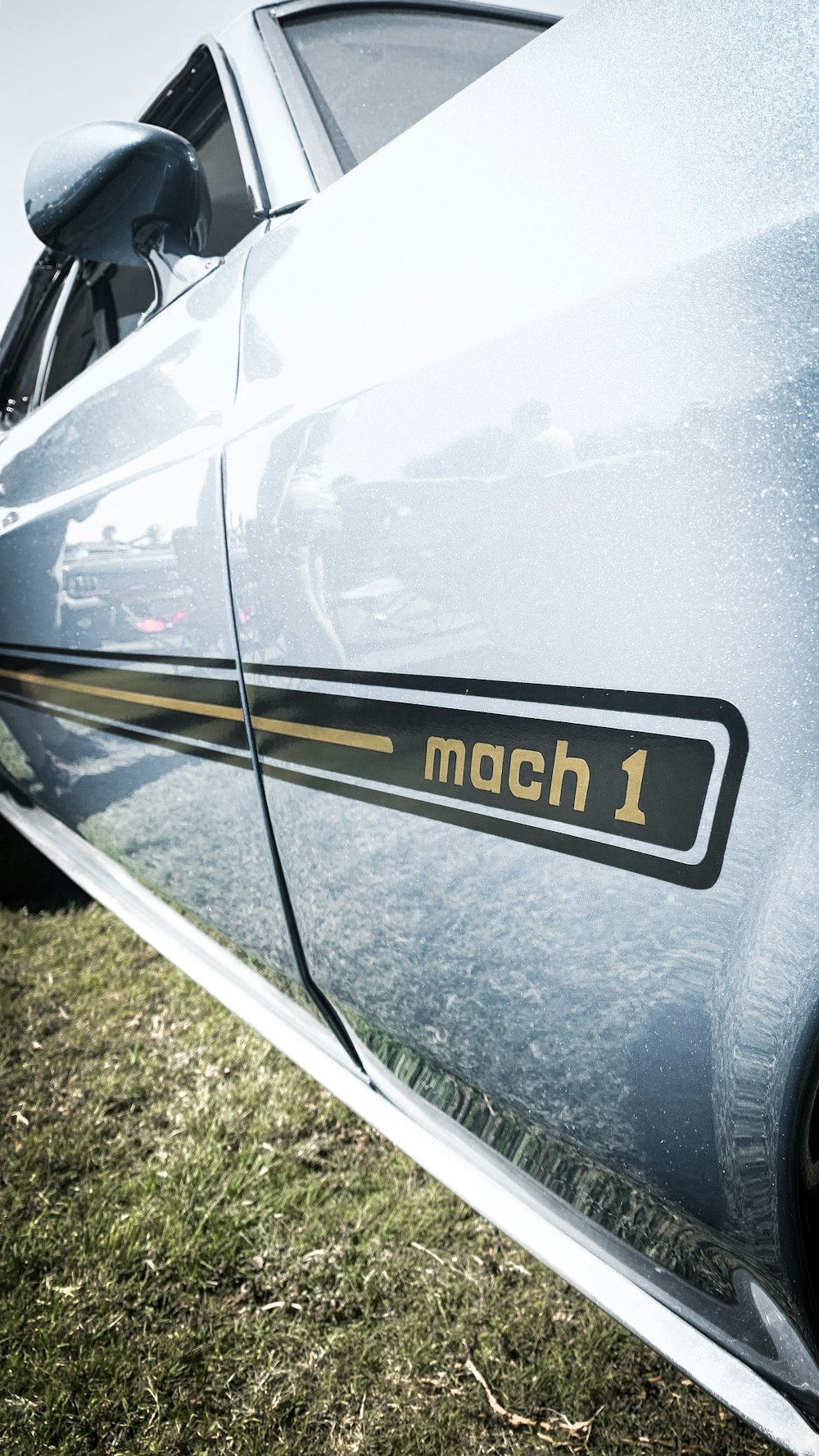 parked gray Mach 1 vehicle during daytime