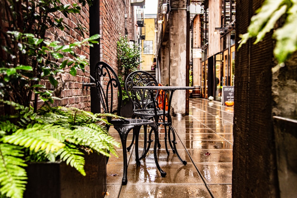 black patio set near bricked wall