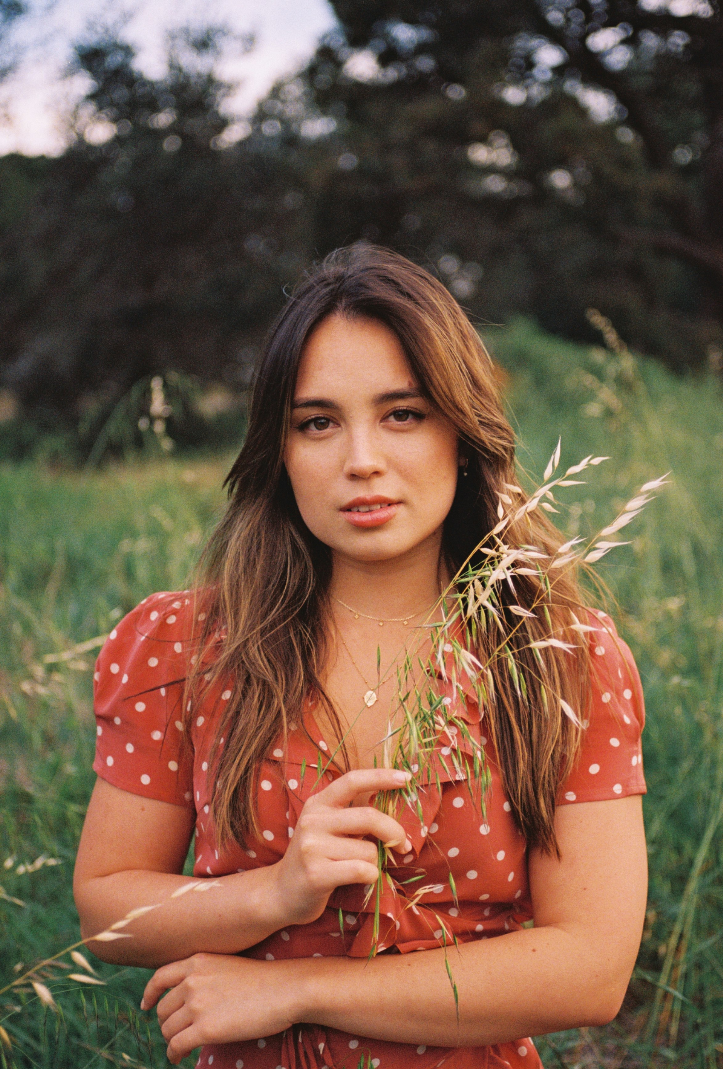 woman holding grass on green grass field