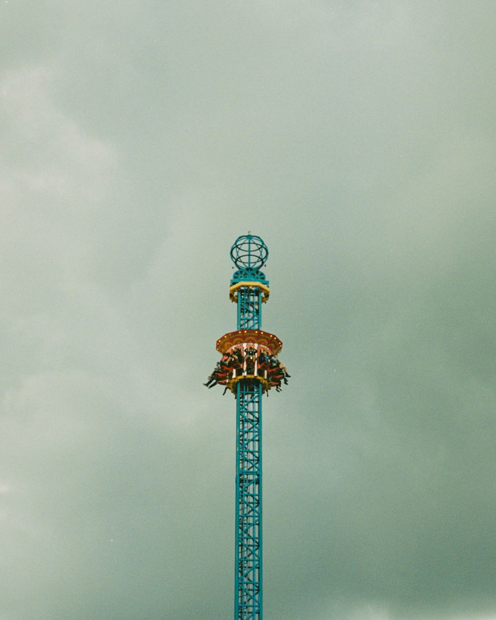 people riding tower amusement park ride