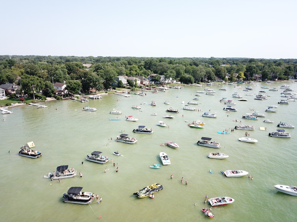 white boats on body of water at daytime