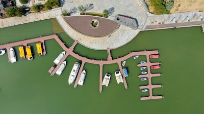 Aerial view of a marina surrounded by lush green parkland.
