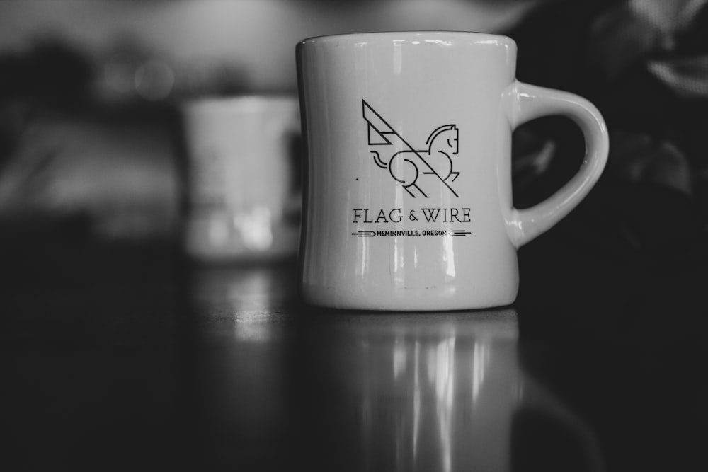 white and black ceramic mug