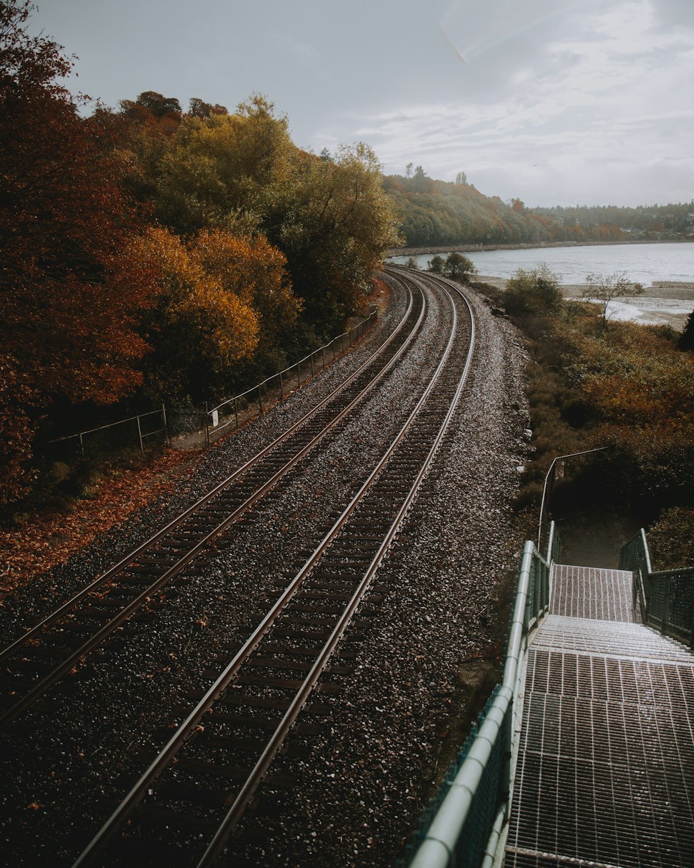 empty train track near shore at daytime