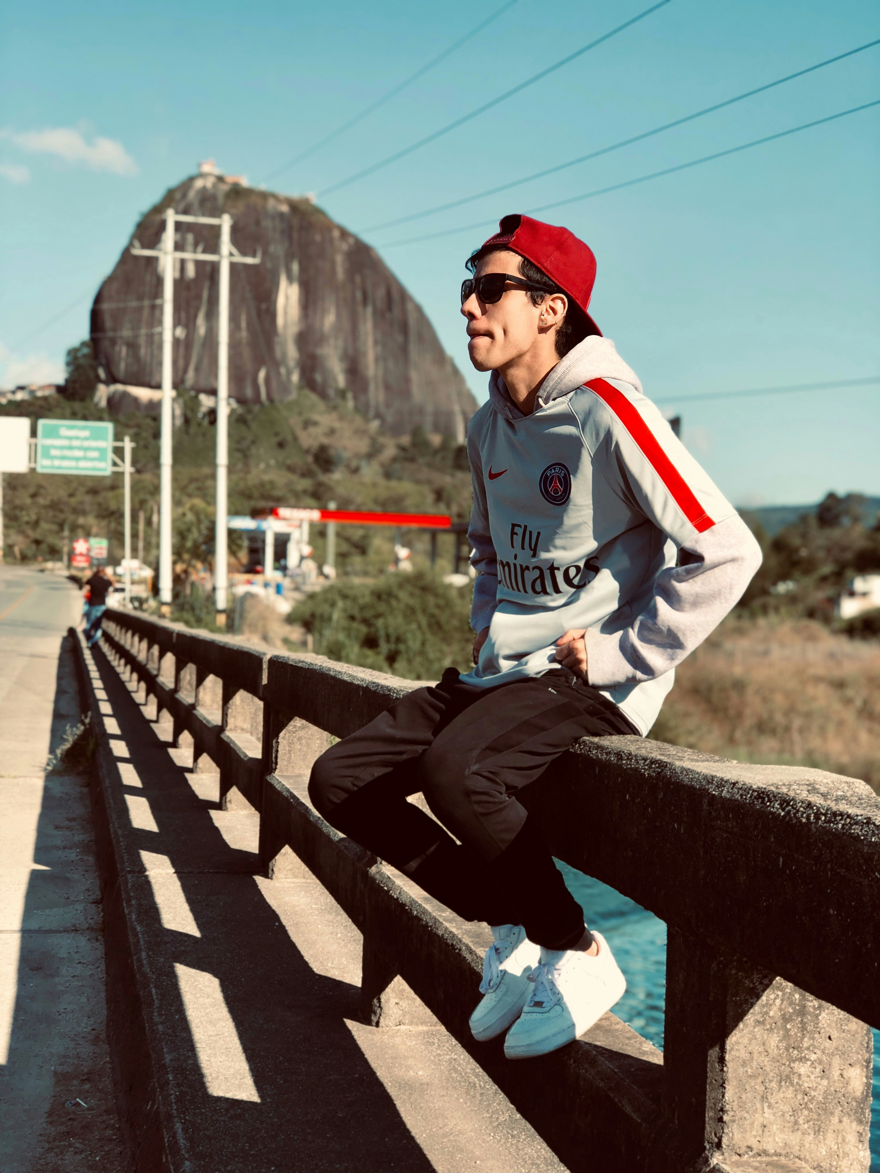 Man sitting on railing photo – Free Building Image on Unsplash