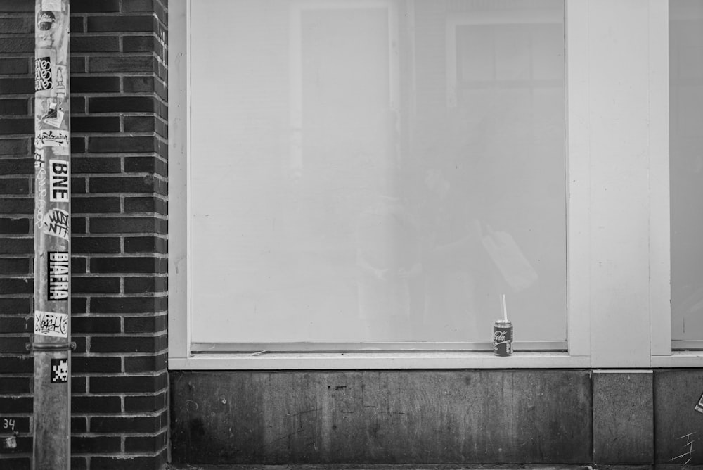 a black and white photo of a person sitting on a bench