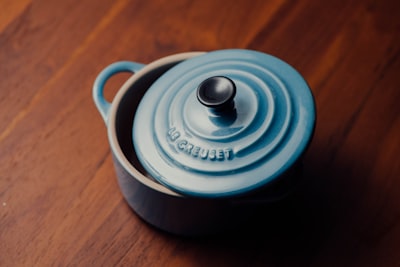 round blue ceramic bowl melting pot teams background