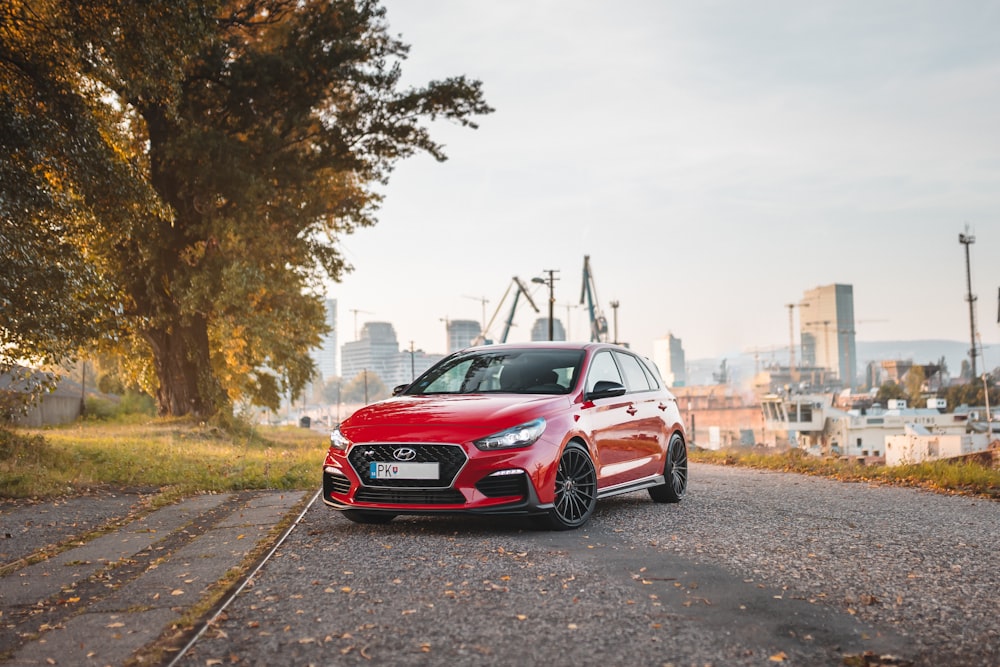 red Hyundai 5-door hatchback on the road