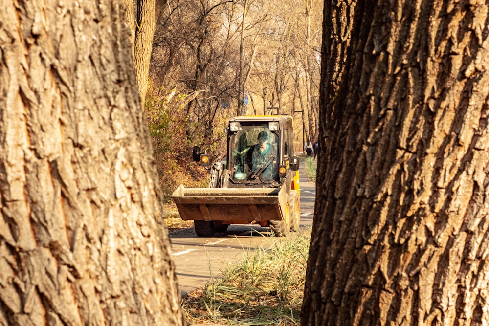 yellow payloader on road during daytime