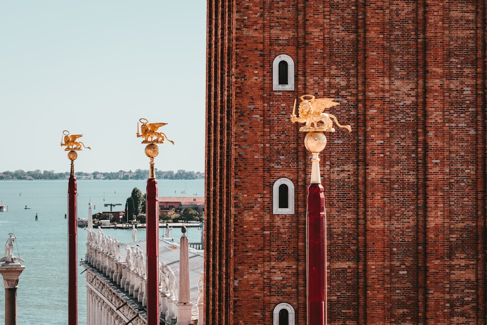 a tall brick building next to a body of water