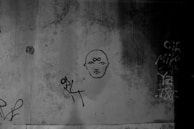 Abstract graffiti art on a studio wall reflecting the gritty, cinematic edge of our music.