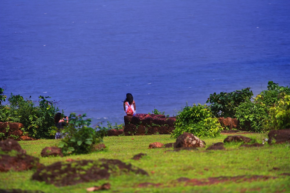 woman sitting on rock