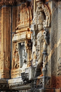 A vibrant close-up of an ancient temple carving showcasing intricate floral patterns and deities.