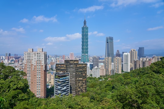 city with high-rise buildings under blue and white sky during daytime in Xiangshan Hiking Trail Taiwan