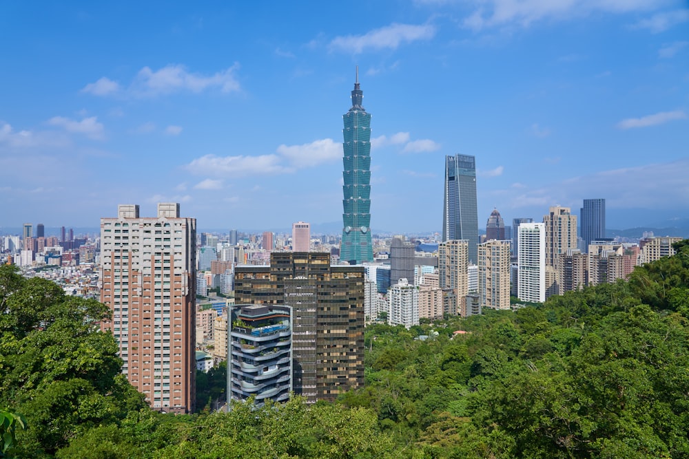 city with high-rise buildings under blue and white sky during daytime