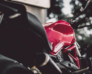 Close-up of a shimmering red motorcycle with detailed flame design paintwork.