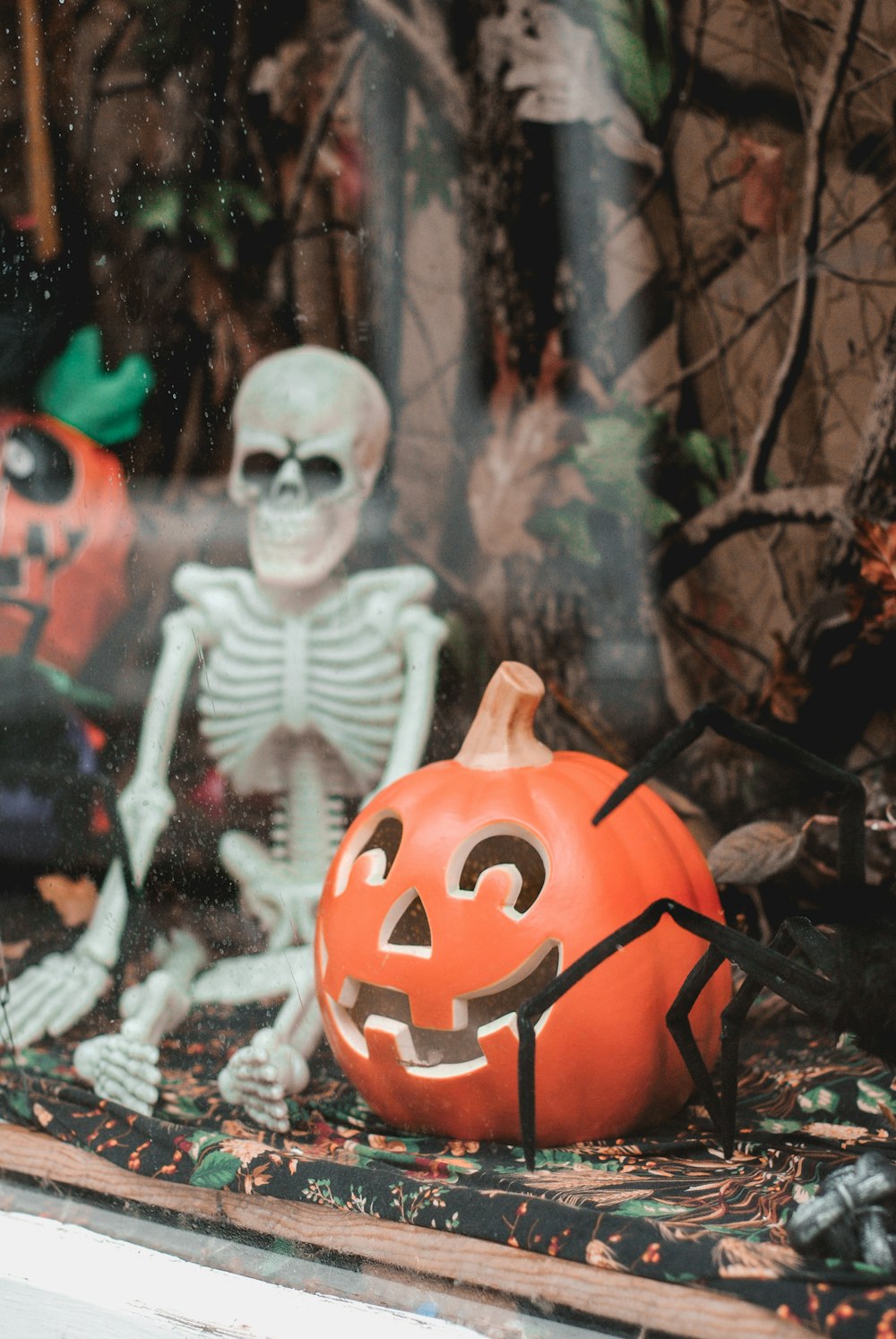 white skeleton and orange pumpkin decor