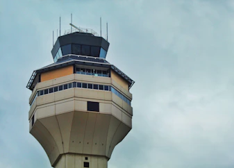 An approachable insurance agent chatting with an air traffic controller in a control tower office.
