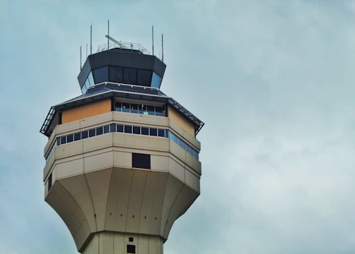 An air traffic control tower overseeing multiple aircraft.