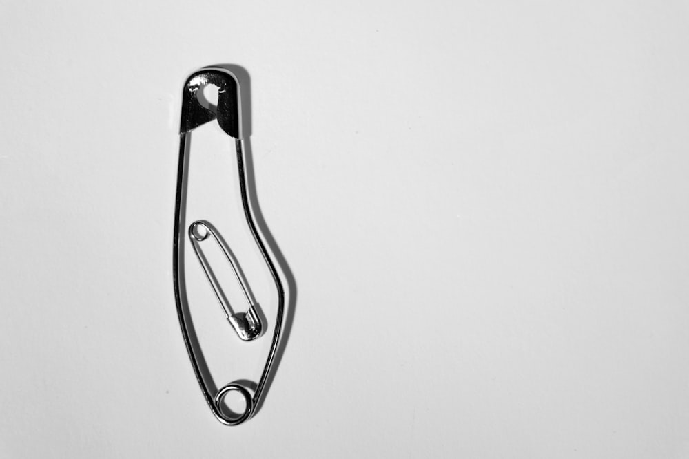 two gray stainless steel safety pins