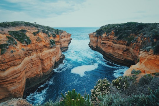 body of water and mountain during daytime in Port Campbell National Park Australia