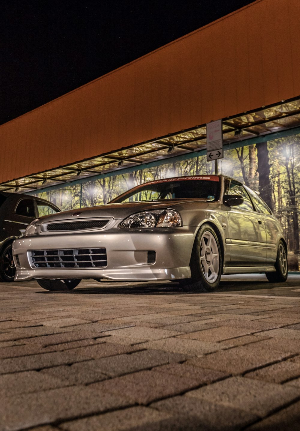 silver Nissan Skyline GT-R coupe parking