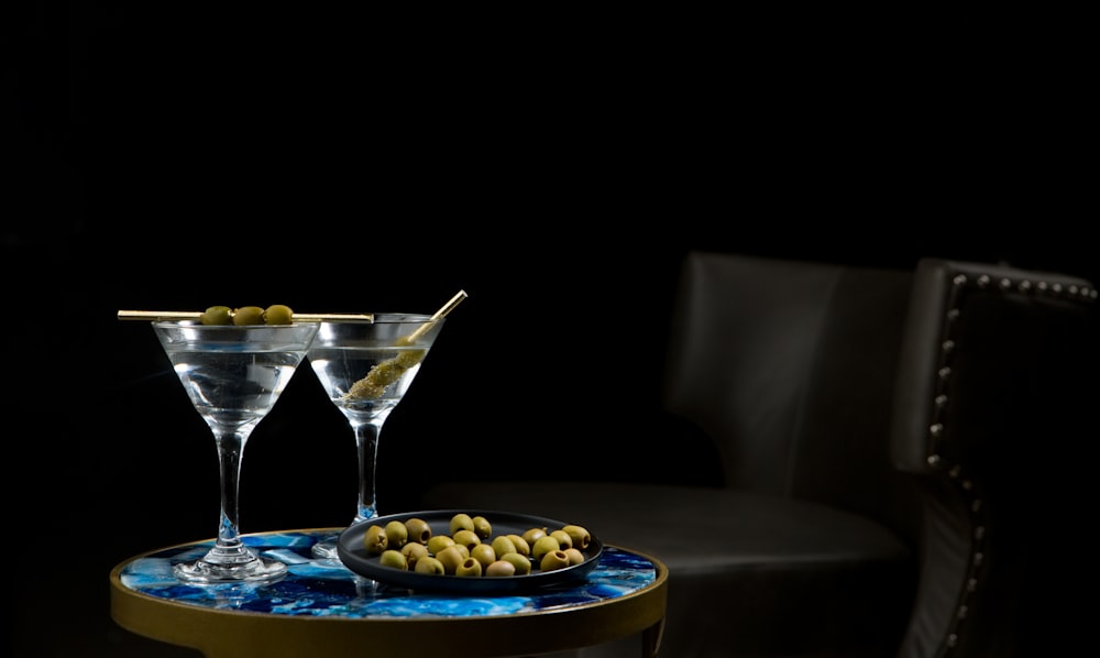 two clear long-stem drinking glass on table