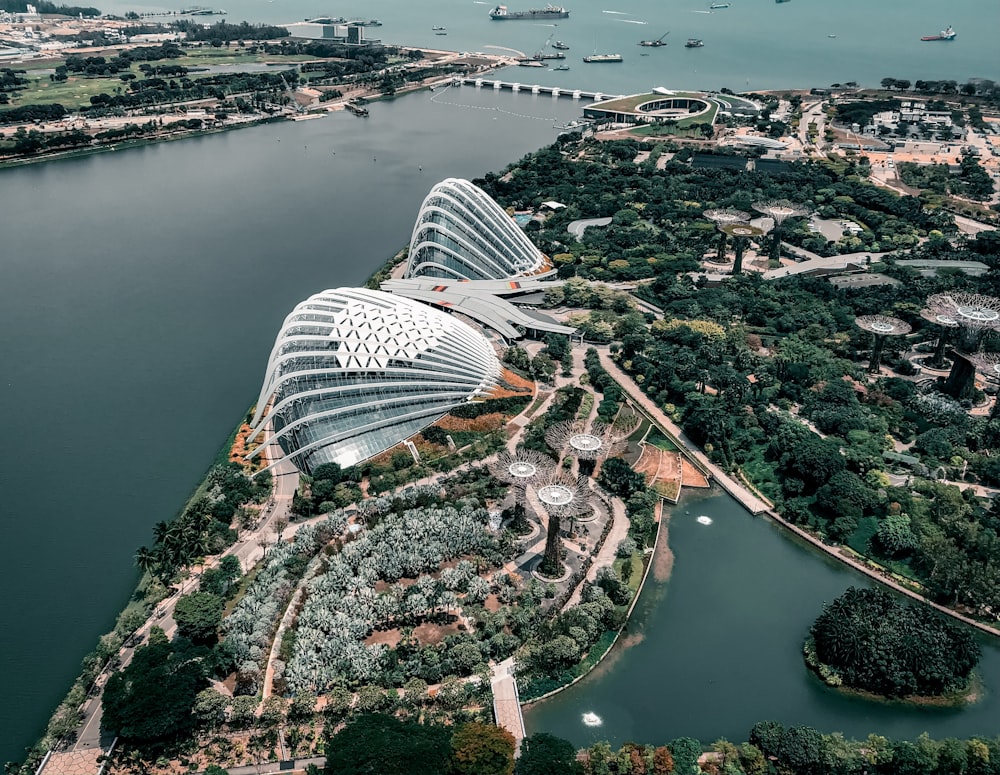 aerial photography of houses and buildings on field viewing blue sea during daytime