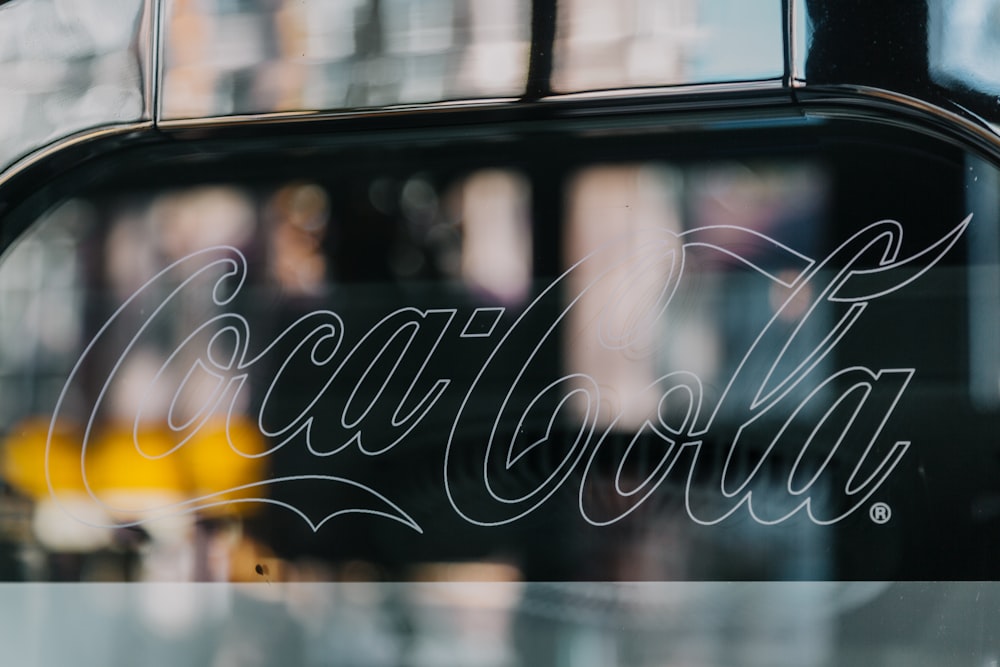 Cola-Cola signage on clear glass window