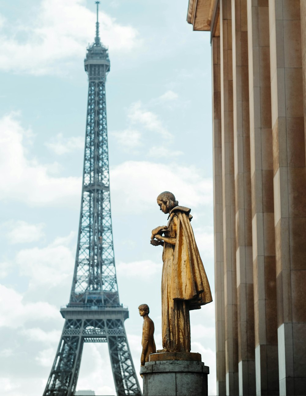two statues near Eiffel Tower